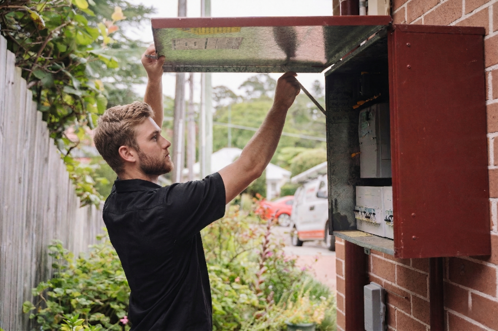 Electrician installing downlights in a Cronulla home